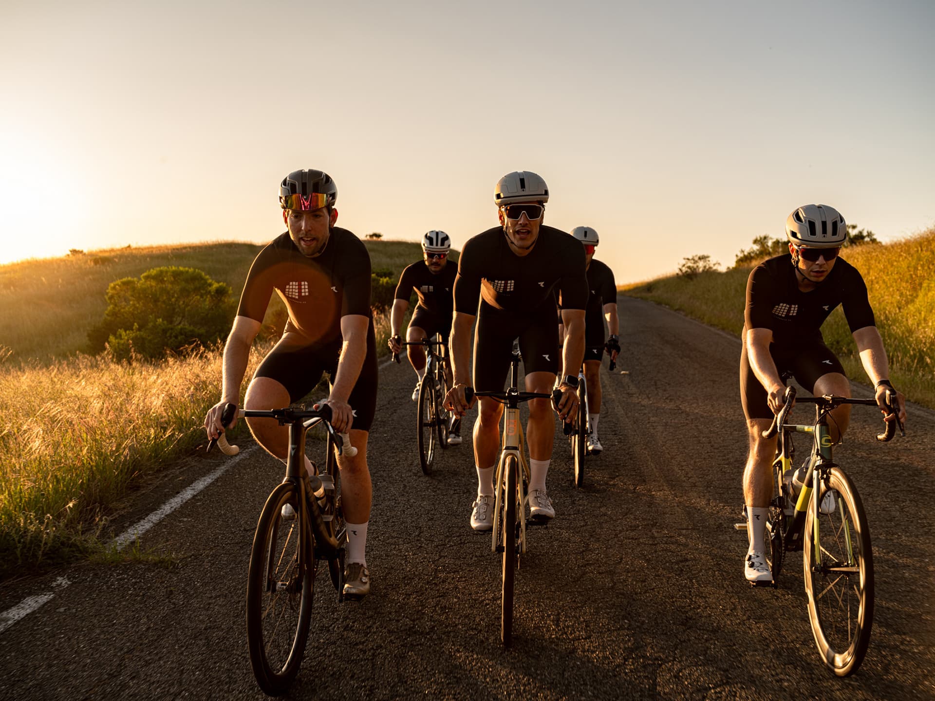 Cyclists riding a golden-hour road north of the Golden Gate