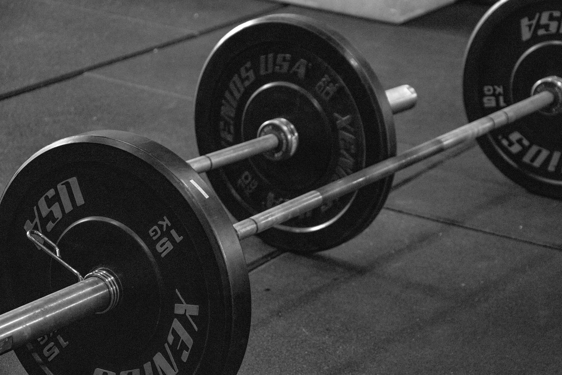 Loaded barbells on a gym floor